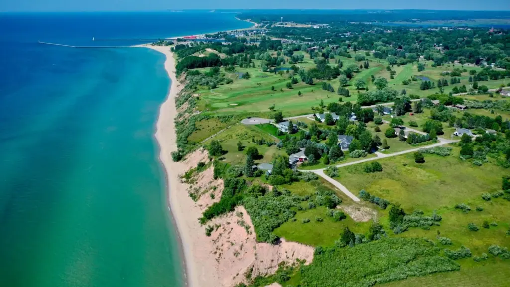 Aerial view of the West Michigan lakeshore with beach, homes, and green open land