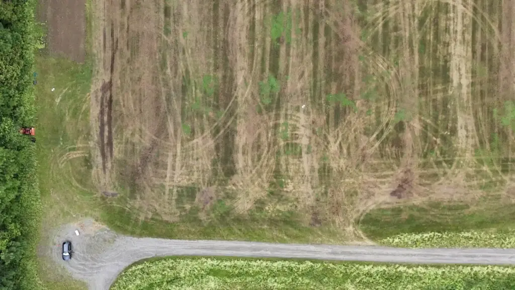 Aerial view of a rural property and access road during a construction site evaluation