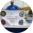 Person holding a community support sign in a circular profile photo