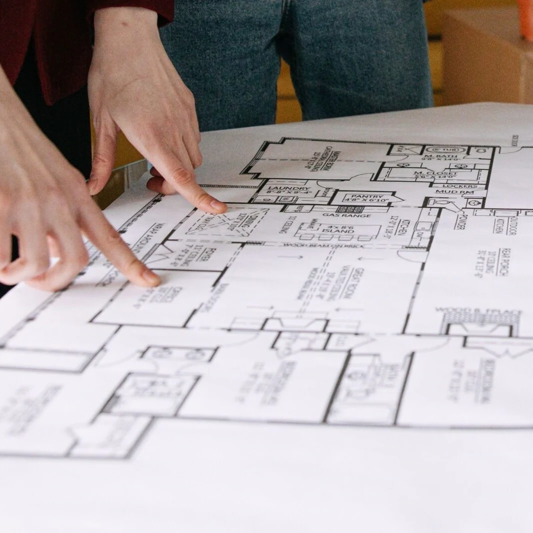 Homeowners reviewing a custom home floor plan during a design consultation