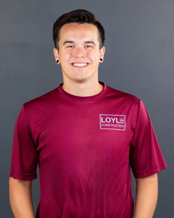Kurt Lang Jr. wearing a branded LOYL Construction shirt against a gray background