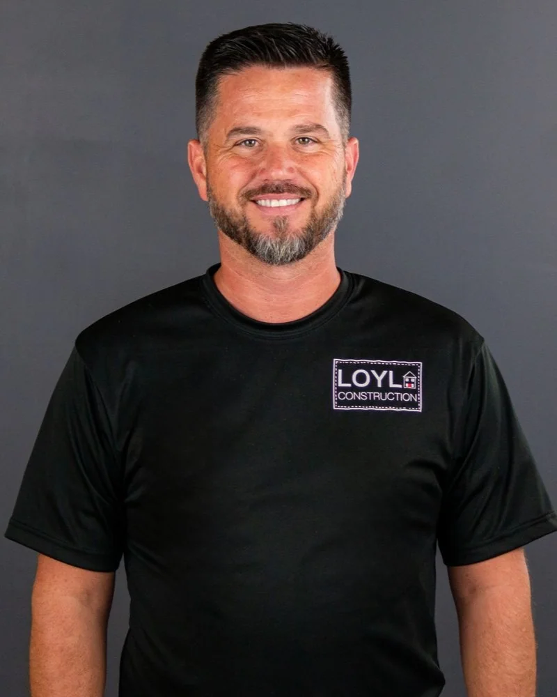 Kurt Lang of LOYL Construction wearing a branded company shirt against a gray background