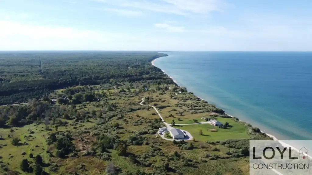 Aerial view of a Lake Michigan waterfront home near a long sandy shoreline