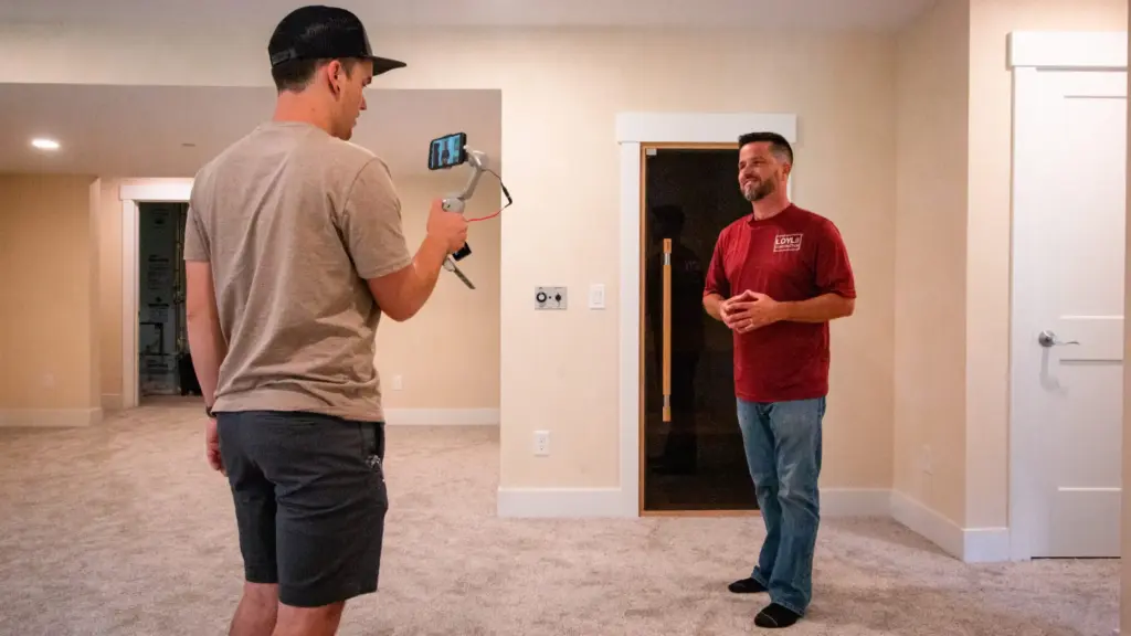 LOYL Construction team member being filmed inside a finished custom home in West Michigan