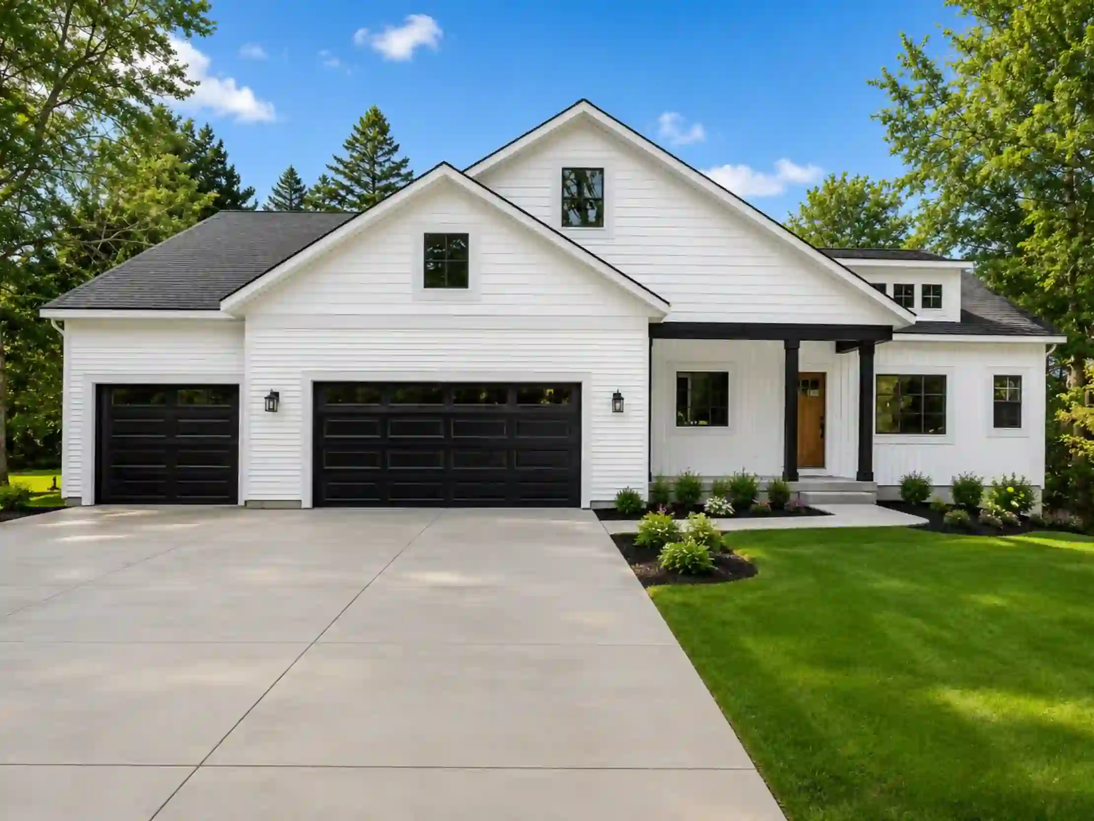 White custom home with black garage doors, covered entry, wood front door, and landscaped lawn in West Michigan