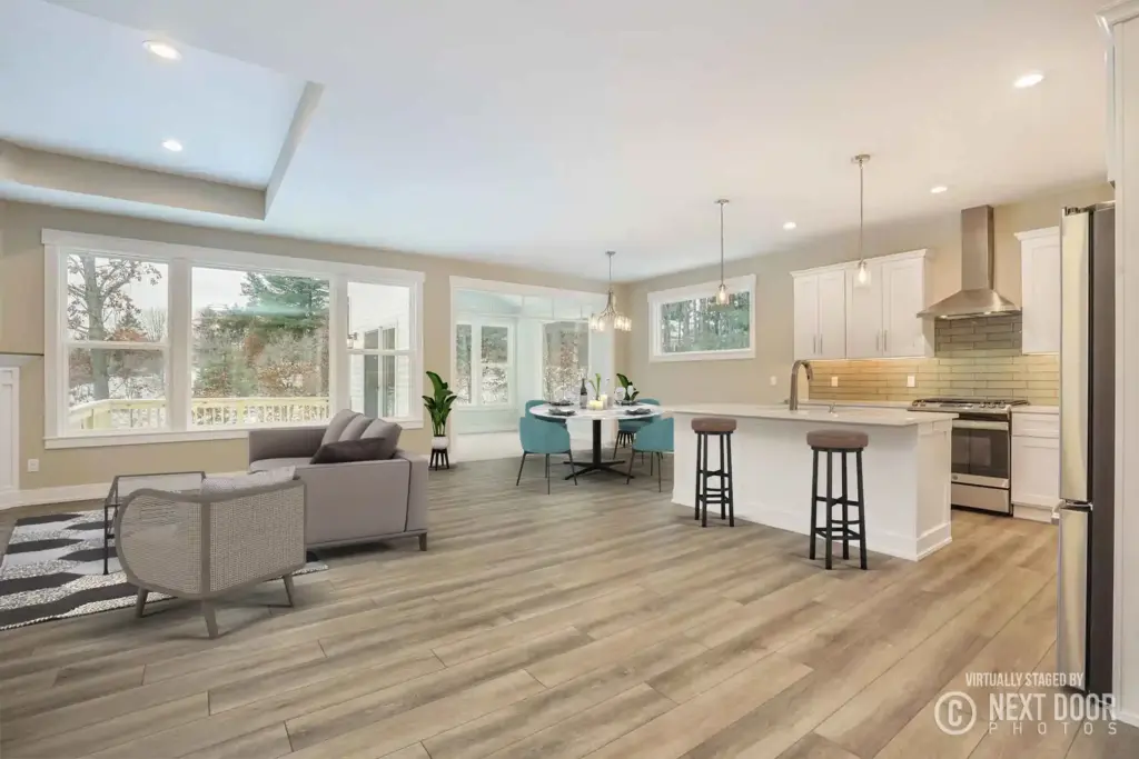 Open-concept custom home kitchen and living area with large windows and wood-look floors