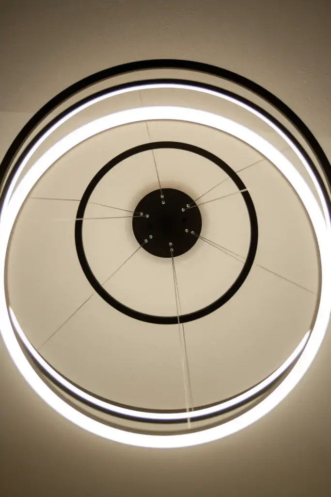 Modern circular LED chandelier in a renovated West Michigan interior