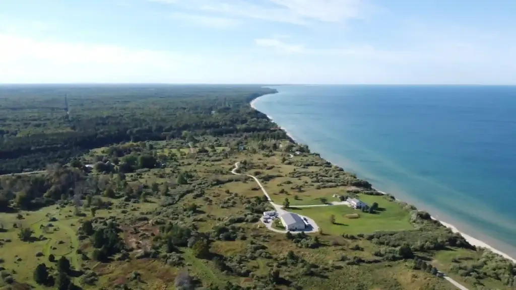 Aerial view of a wooded lakefront property along the West Michigan shoreline